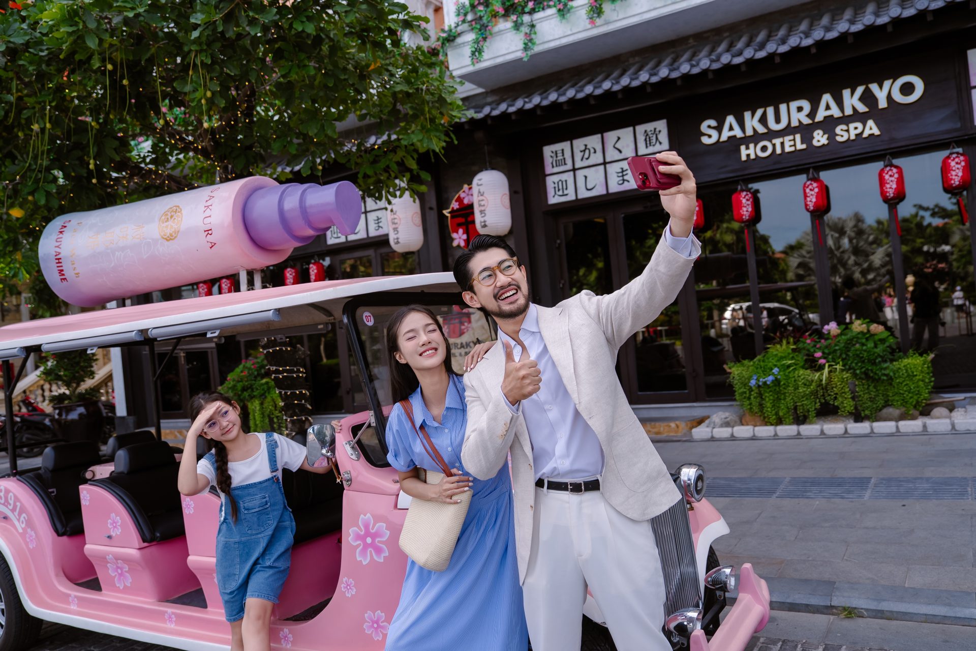 Family riding an electric car on a Sunset Town tour outside Sakurakyo Hotel & Spa, Phu Quoc