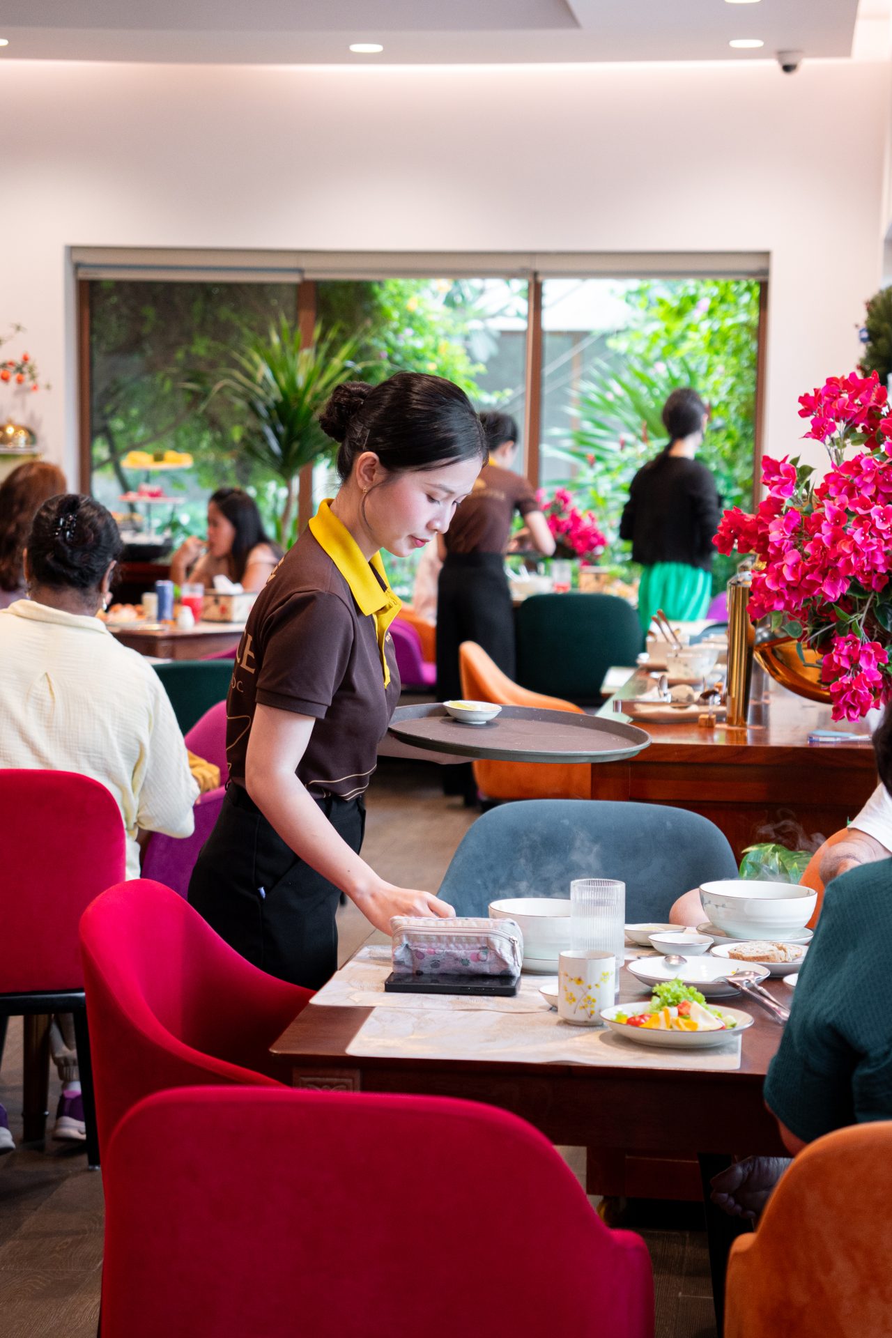Staff serving breakfast at the hotel restaurant in Sunset Town, Phu Quoc